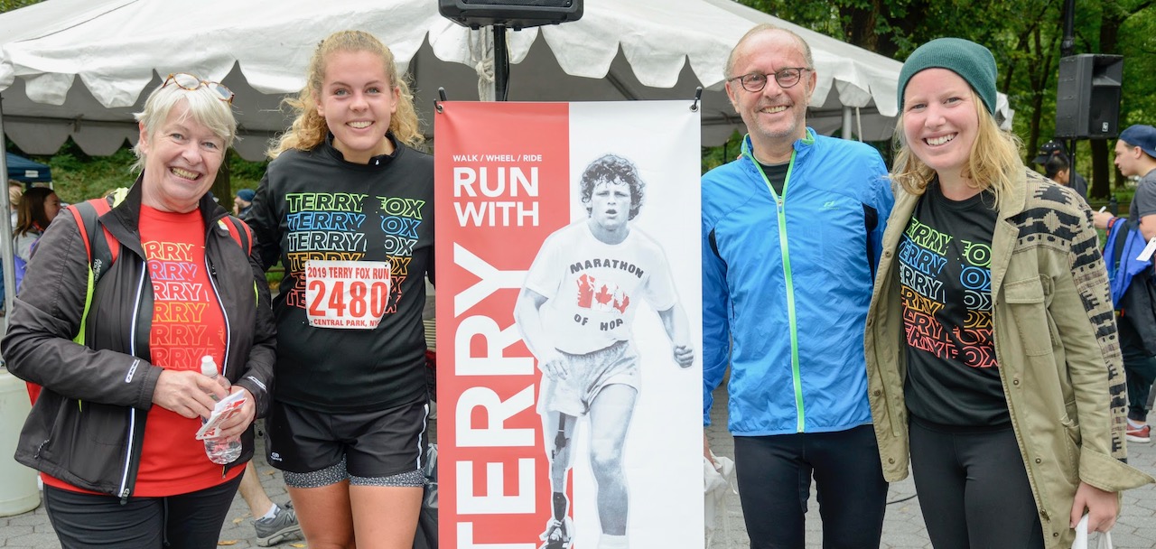 A family of four smiling at the Terry Fox Run event in Central Park